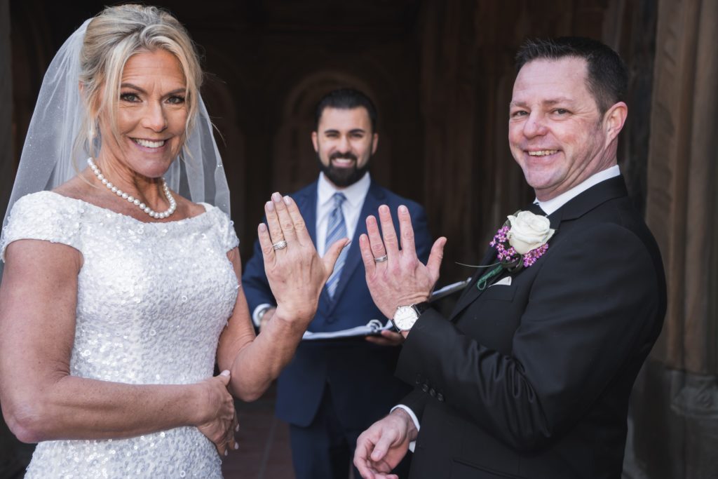 Wedding officiant speaking with a couple during their ceremony