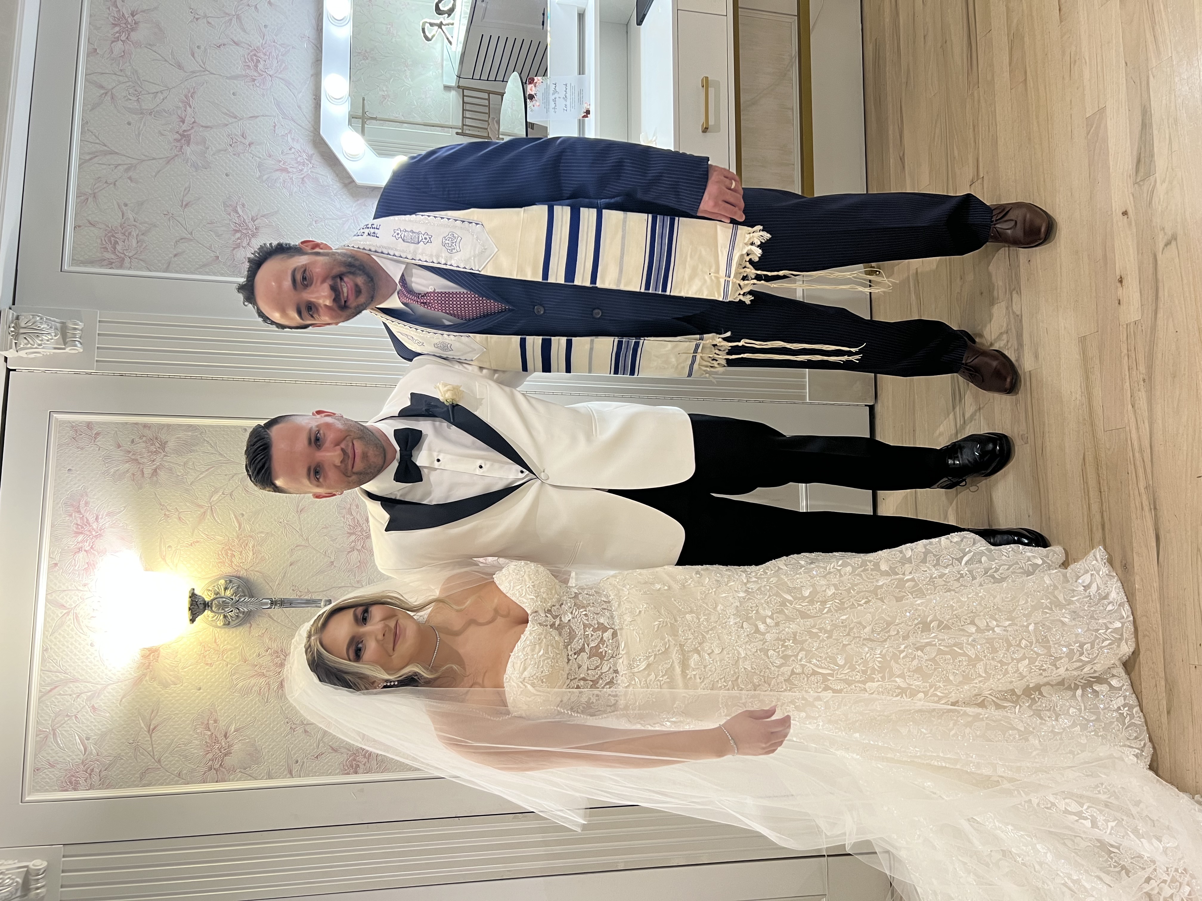Newly married couple standing with their New York wedding officiant